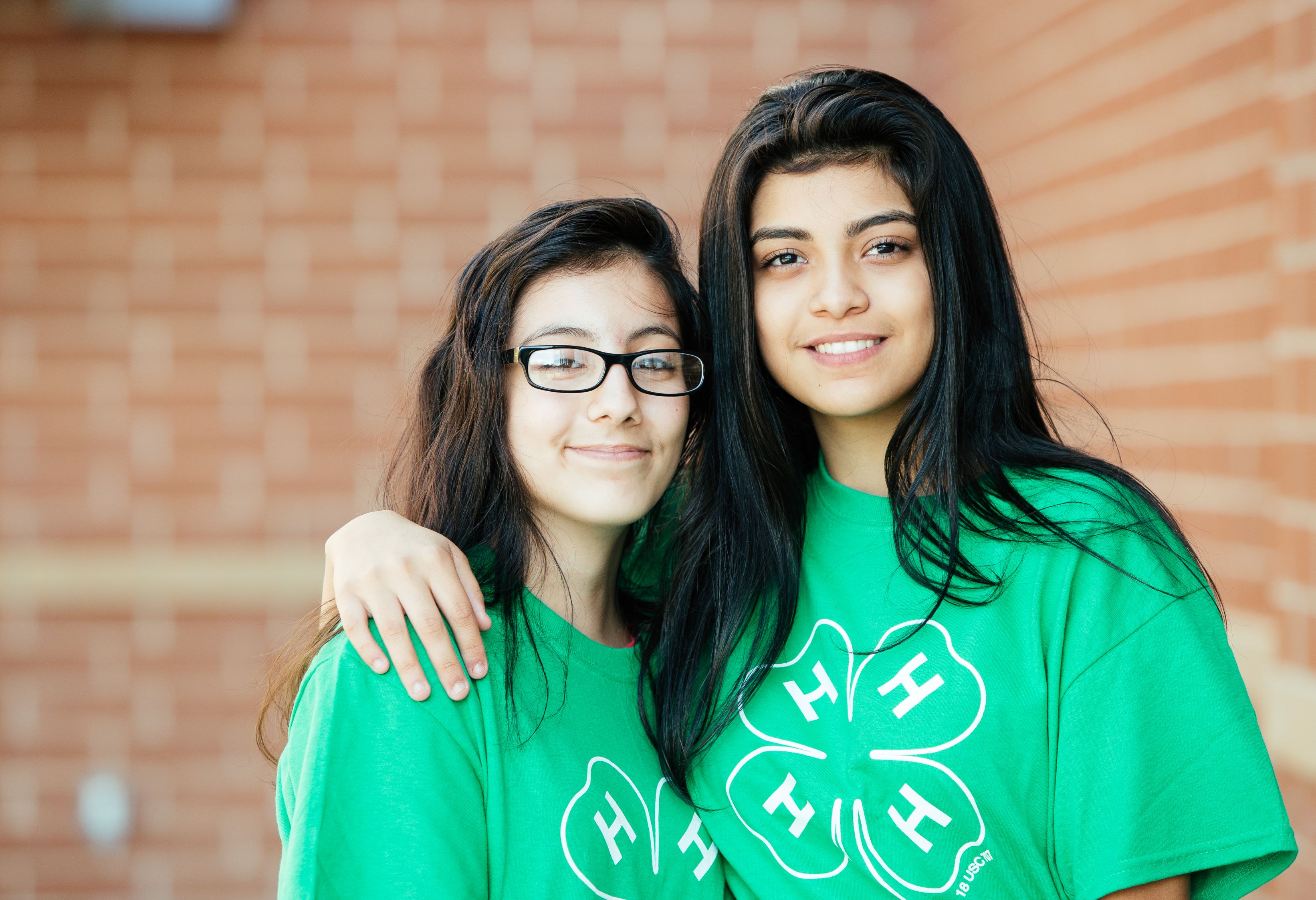 Two Girls Smiling Into Camera wearing Green 4-H shirts 